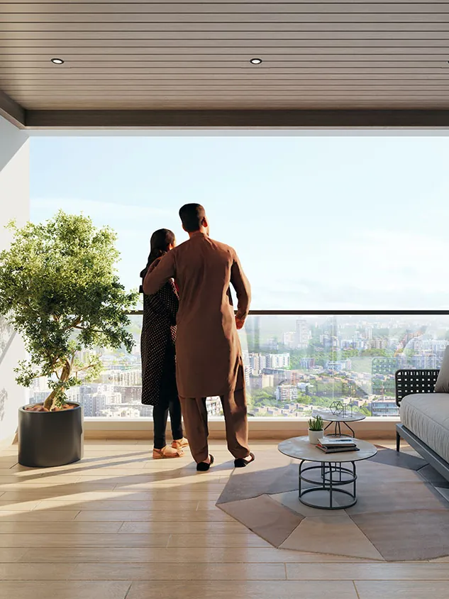 A couple at the window of a living room, with the city beyond