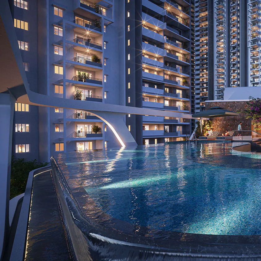 The infinity pool on the podium at dusk, below the lit towers